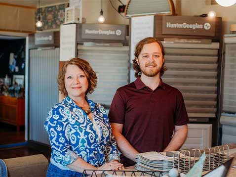 Business owners posing for a photo in the showroom