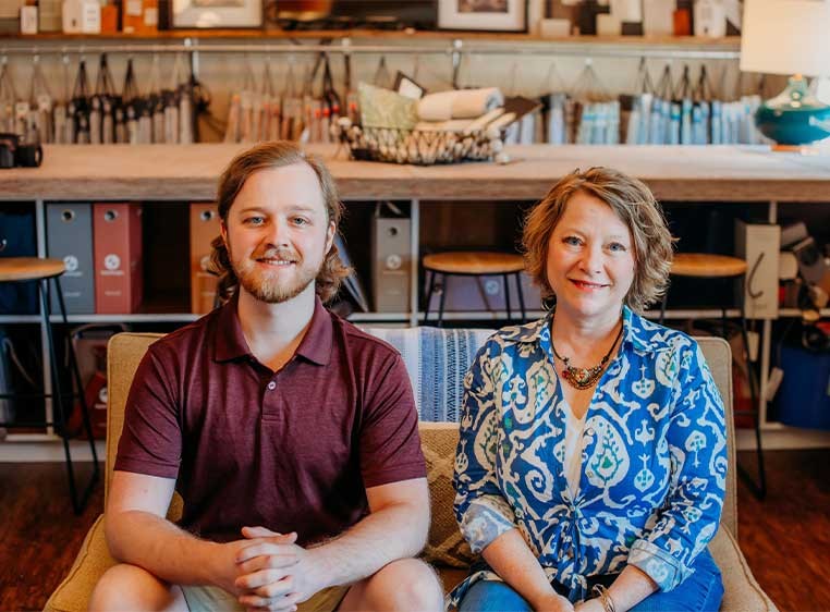 Business owners posing for a photo in the showroom